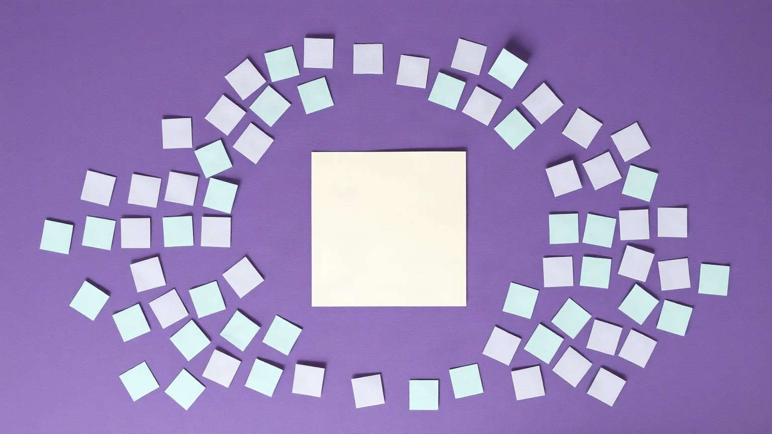 Many small pale paper squares arranged in a wide ring on a violet ground, one larger cream square alone at the centre of it
