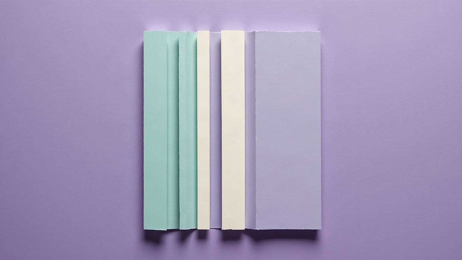 A pale square cut into upright strips of differing widths in mint, cream and grey-blue, standing together on a lilac ground